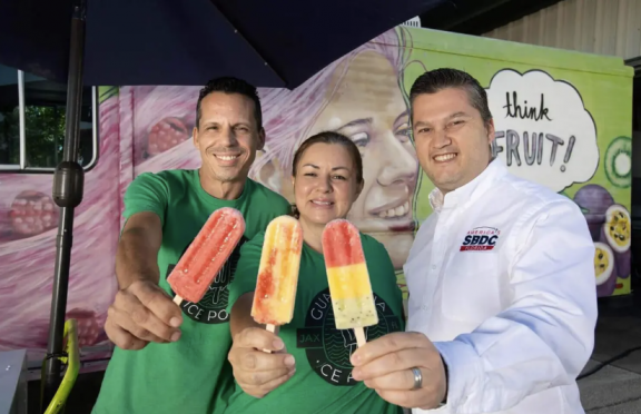 3 people holding popcicles